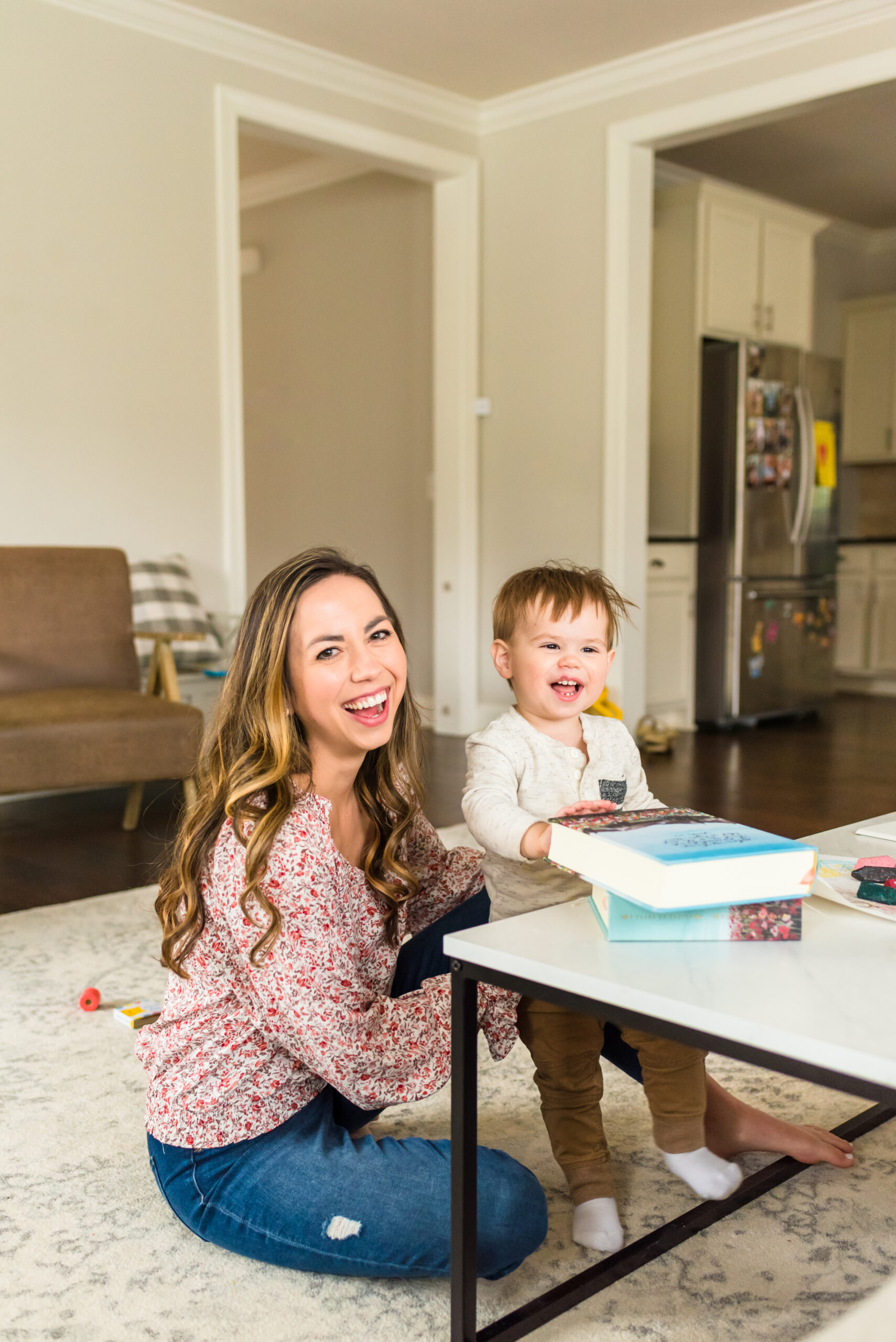 woman sitting on the floor reading the Bible with her toddler