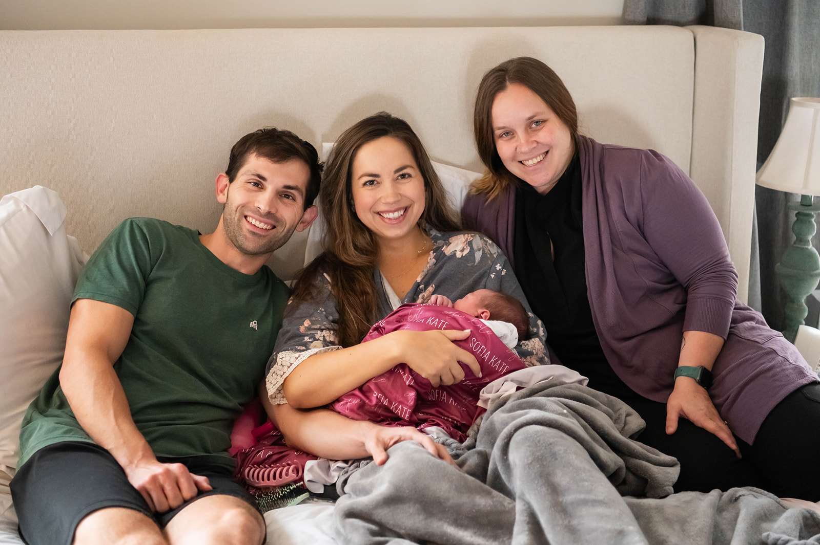 mom dad and midwife after a home birth